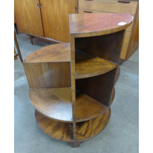 80 - An Art Deco circular walnut coffee table/bookcase