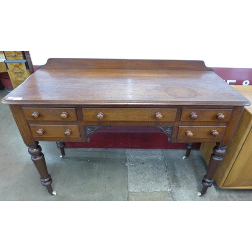 82 - A Victorian mahogany five drawer writing table