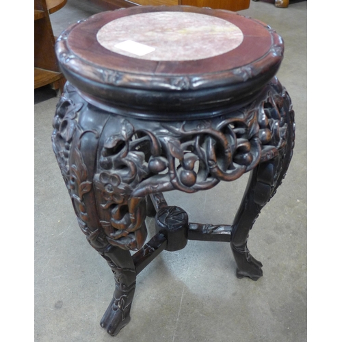 85 - A Chinese carved padouk wood and marble topped jardiniere stand