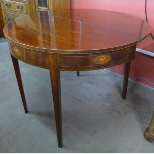 86 - A George III inlaid mahogany demi-lune fold over tea table