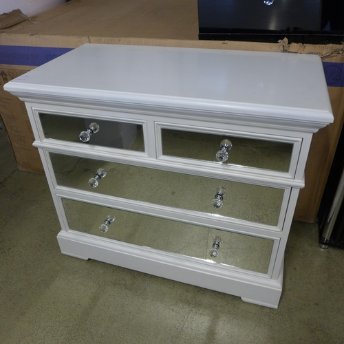 1581 - A white painted and mirrored two over three chest of drawers