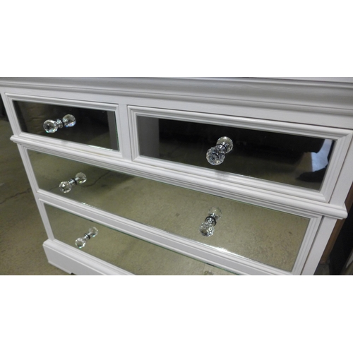 1581 - A white painted and mirrored two over three chest of drawers