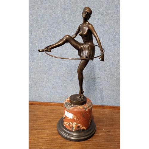 325 - An Art Deco style bronze figure of a female dancing hoop girl, on rouge marble socle