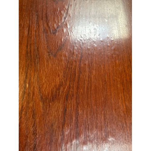 1594 - A rosewood effect dining table with metal base