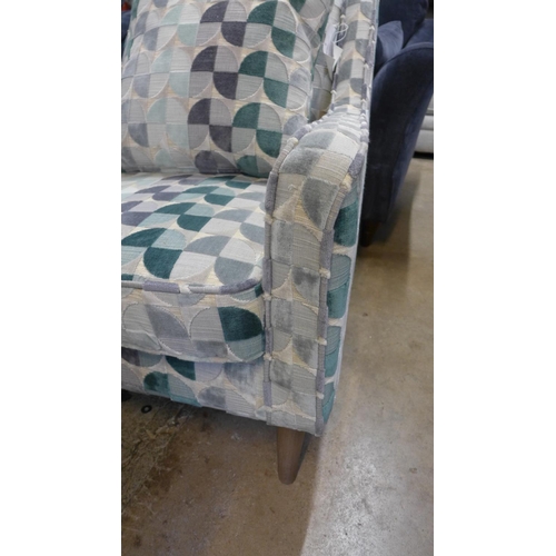 1303 - A cream, teal and grey patterned upholstered armchair