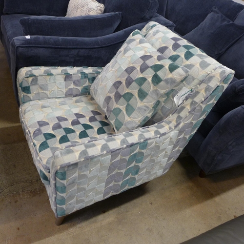 1303 - A cream, teal and grey patterned upholstered armchair