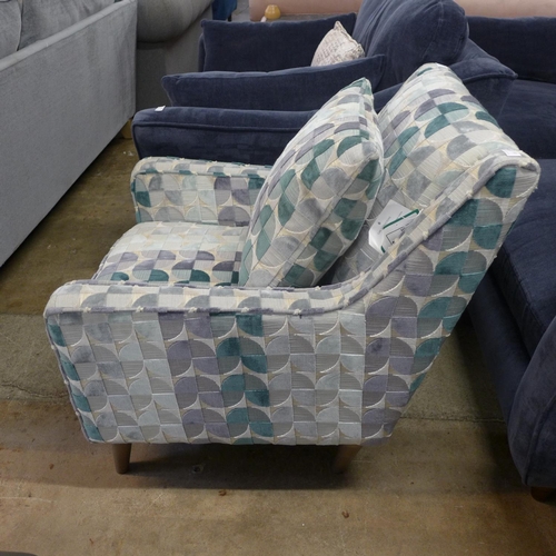 1303 - A cream, teal and grey patterned upholstered armchair