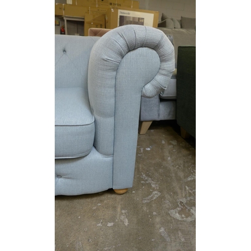 1309 - A light grey textured weave Chesterfield style love seat