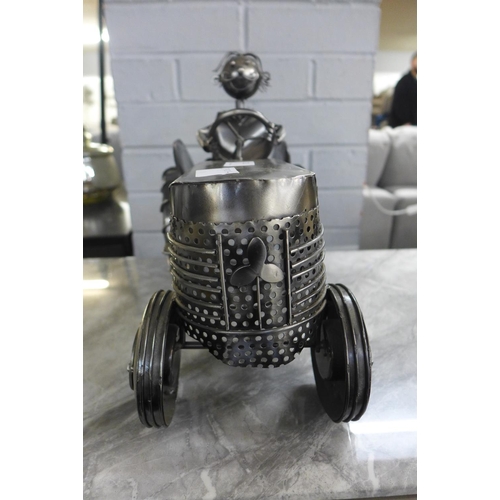 1321 - A metal wine bottle holder in the form of a man on tractor (6)