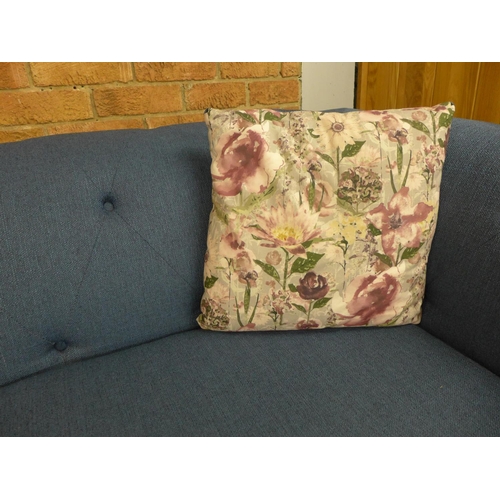 1526 - A pair of blue textured weave upholstered Chesterfield sofas with patterned scatter cushions