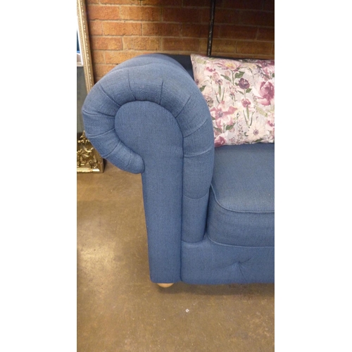 1526 - A pair of blue textured weave upholstered Chesterfield sofas with patterned scatter cushions