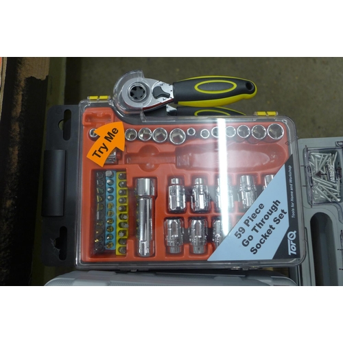 2051 - A box of assorted tool sets, electric wallpaper cutter, hole saw blades, socket sets and more