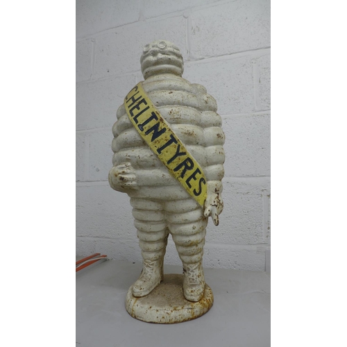 2073 - A cast iron Michelin tyres 'Michelin Man' ornament - approximately 2ft