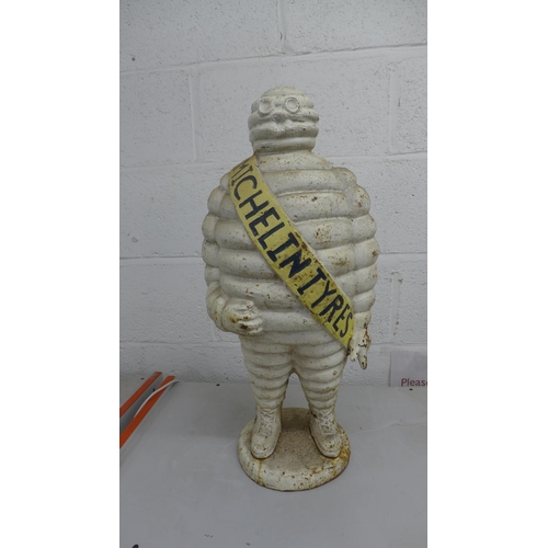 2073 - A cast iron Michelin tyres 'Michelin Man' ornament - approximately 2ft