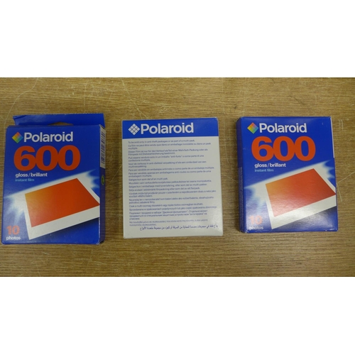 2149 - Four Polaroid cameras with 3 packs of film