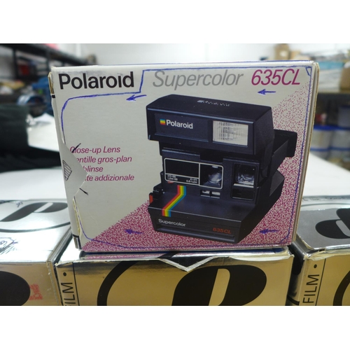 2149 - Four Polaroid cameras with 3 packs of film