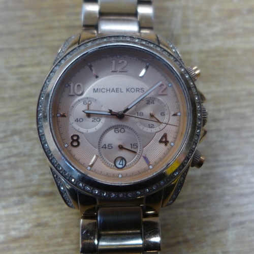 2150 - A Michael Kors pink faced wristwatch