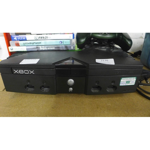 2176 - An original Xbox console with a Mad Catz controller pad and a selection of mostly PS3 games includin... 