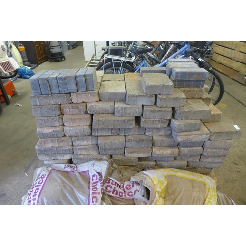 2224 - A pallet of paving blocks:- small, medium and large tegula blocks and 5 bags of builders sand