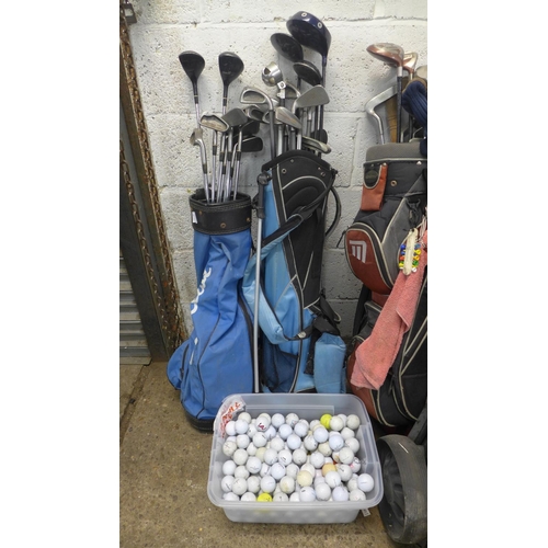 2228 - 3 golf bags with quantity of woods, irons and golf trolley with a tub of Approx. 150 golf balls