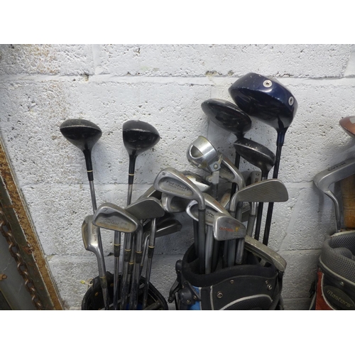 2228 - 3 golf bags with quantity of woods, irons and golf trolley with a tub of Approx. 150 golf balls