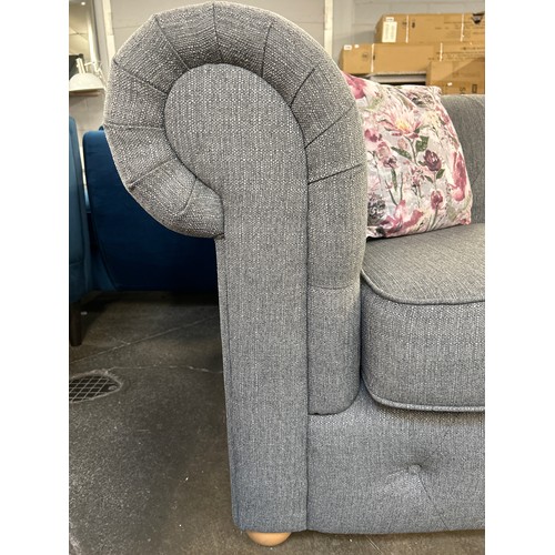 1308 - A grey textured weave upholstered Chesterfield style two seater sofa