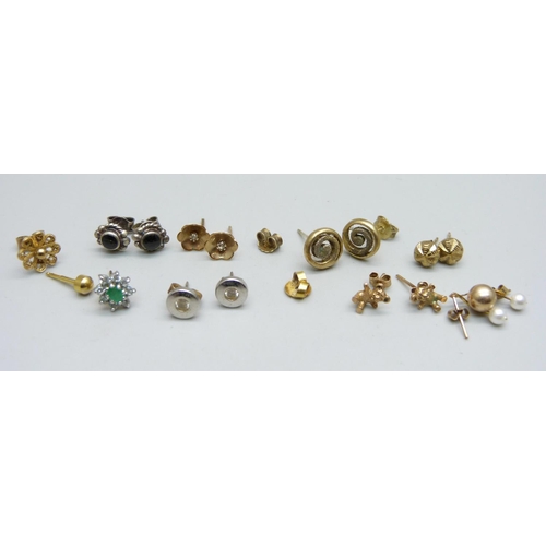 1006 - Six pairs of earrings and five single earrings, including one pair marked 9ct gold, 0.5g, and one si... 