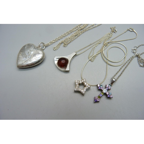 1058 - A silver locket and chain and three silver pendants and chains, 28g