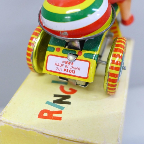 644 - A small Chinese tin plate toy tricycle, boxed