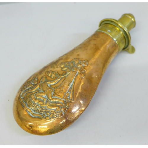 652 - A brass and copper powder flask with embossed scene, marked R.A.R. Jones