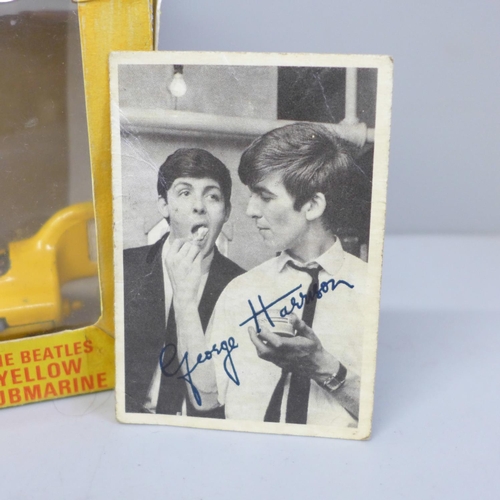 653 - A Corgi Toys The Beatles Yellow Submarine, boxed and a facsimile signed picture card of George Harri... 