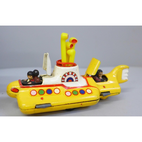 653 - A Corgi Toys The Beatles Yellow Submarine, boxed and a facsimile signed picture card of George Harri... 