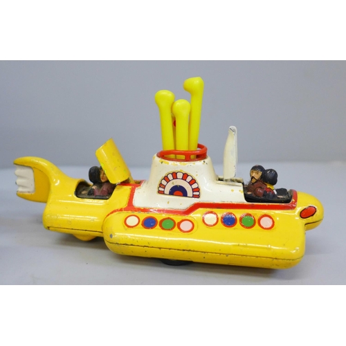 653 - A Corgi Toys The Beatles Yellow Submarine, boxed and a facsimile signed picture card of George Harri... 