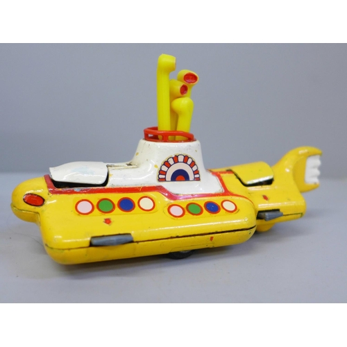 653 - A Corgi Toys The Beatles Yellow Submarine, boxed and a facsimile signed picture card of George Harri... 