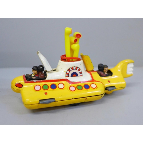 653 - A Corgi Toys The Beatles Yellow Submarine, boxed and a facsimile signed picture card of George Harri... 