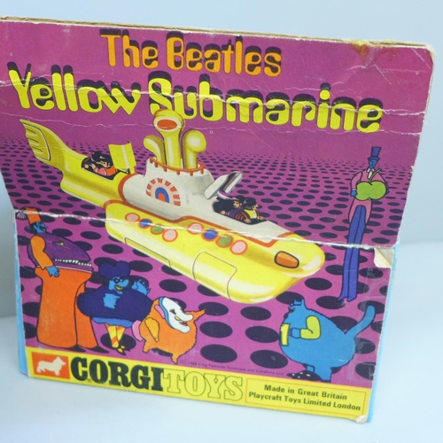 653 - A Corgi Toys The Beatles Yellow Submarine, boxed and a facsimile signed picture card of George Harri... 