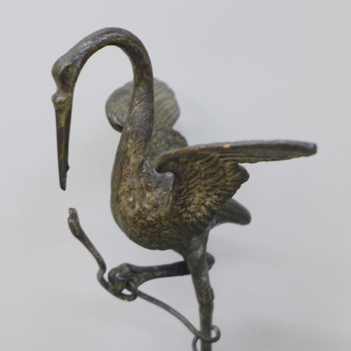 656 - A bronze model of a bird standing on a turtle, on a quartz base