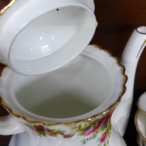 702 - A Royal Albert Old Country Roses coffee and tea service, one coffee cup, tea cup and cream jug a/f, ... 