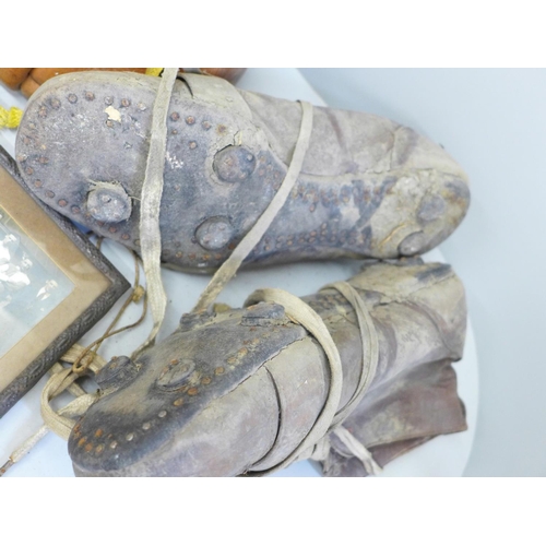 763 - Three pre-war leather footballs, a pair of football boots and a small framed photograph of a footbal... 