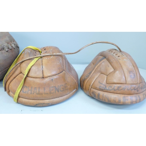 763 - Three pre-war leather footballs, a pair of football boots and a small framed photograph of a footbal... 