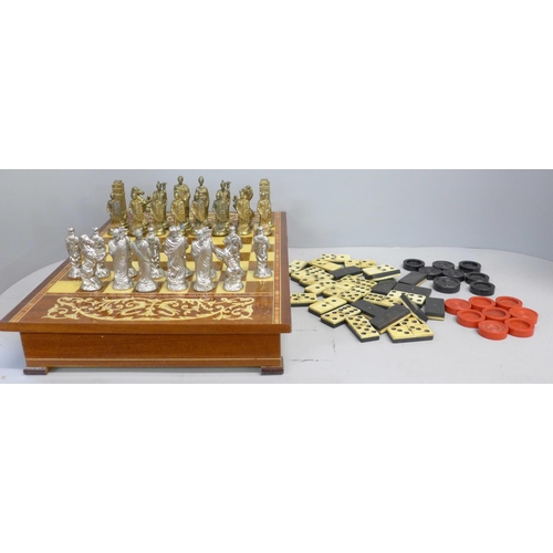 792 - A games compendium; a bone dominoes set, draughts and a Chess board with pieces (two rooks missing)