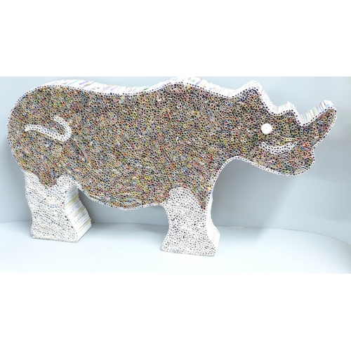 805 - A rhinoceros artwork made from rolled magazine cuttings, 57cm