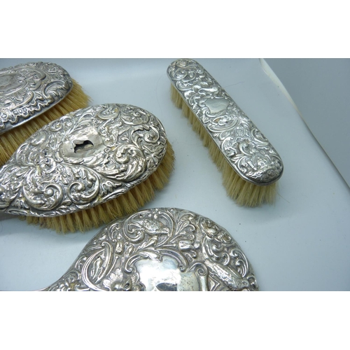 912 - A silver backed mirror and brushes, a/f