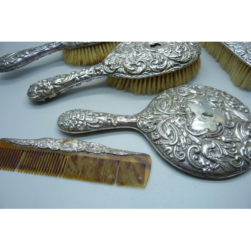 912 - A silver backed mirror and brushes, a/f