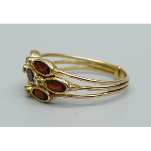 945 - An 18ct gold and garnet ring, marks to back of shank, 3.6g, T