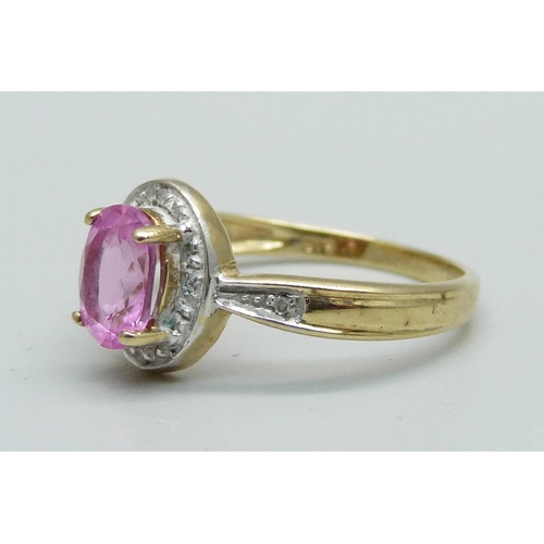 951 - A 9ct gold ring set with a pink stone and diamonds, 2.2g, N