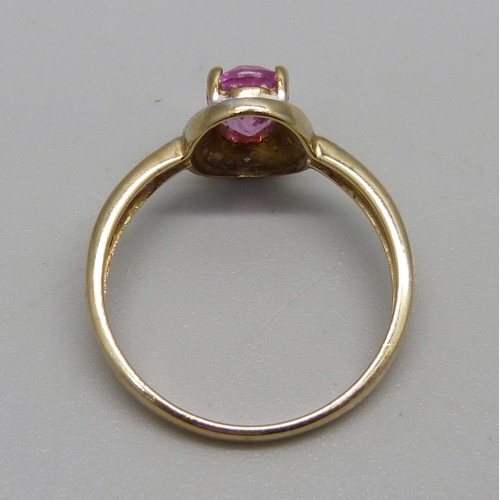 951 - A 9ct gold ring set with a pink stone and diamonds, 2.2g, N