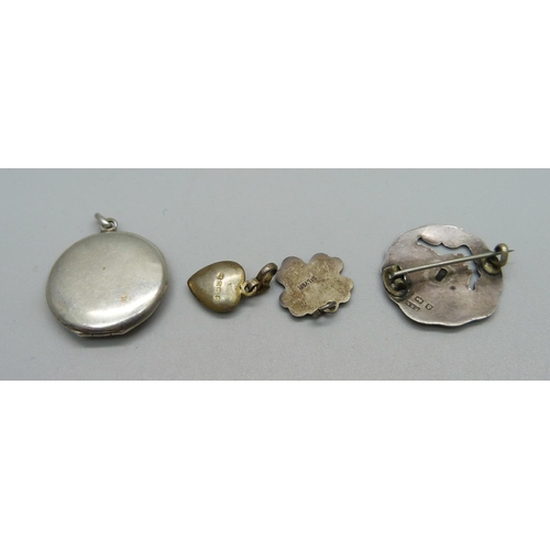 956 - A 935 silver and enamelled locket, an Art Nouveau  silver brooch, made from a button, a hallmarked s... 