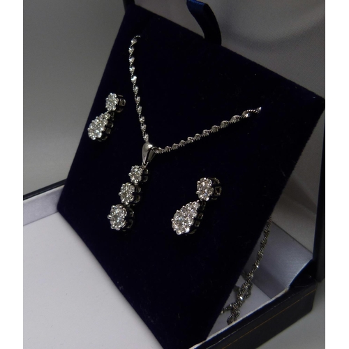 973 - A 14ct white gold and diamond triple cluster drop pendant and chain and matching earrings (silver sc... 