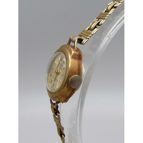 987 - A lady's 9ct gold Precimax wristwatch on a 9ct gold strap, total weight with movement 12g, boxed